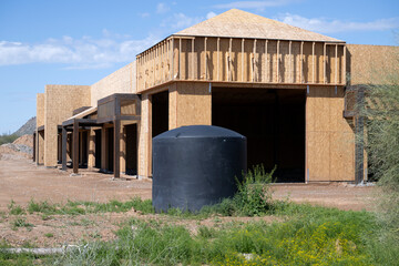 A water reservoir in front of a building in construction