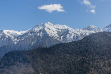 Fototapeta na wymiar Snow covered peaks near Siguniangshan town in Sichuan province, China