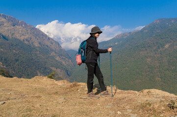 A young traveller trekking on forest trail , Nepal