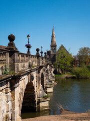 The stone arches of the 18th century Grade II listed English Bridge which crosses the River Severn in Shrewsbury, UK. Clear blue sky. Space for text.