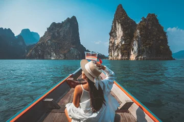 Foto op Canvas Traveler asian woman relax and travel on Thai longtail boat in Ratchaprapha Dam at Khao Sok National Park Surat Thani Thailand © Peera