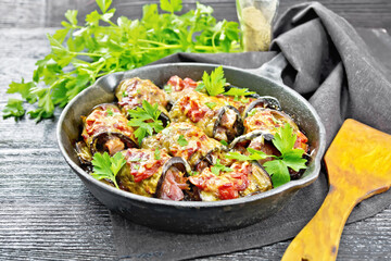 Rolls of eggplant with meat in pan on board