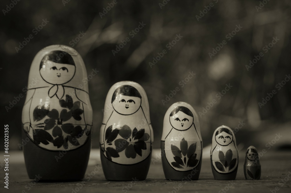 Wall mural A row of nesting dolls in close-up. Slavic culture. Matryoshka. Black and white photo.