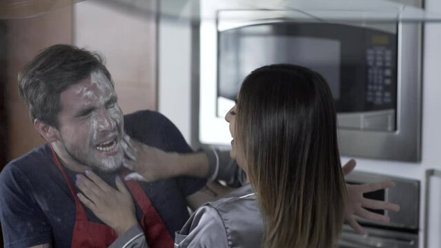 Man and woman fooling around in the kitchen-Playing with flour