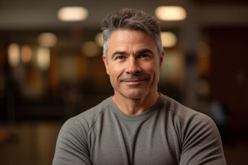 Obraz premium Portrait of a handsome middle-aged man with grey hair smiling at the camera