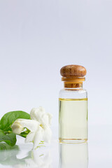 White mogra or arabian jasmine or Jasminum sambac flower Buds Essential oil in glass bottle beauty treatment.