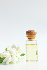 White mogra or arabian jasmine or Jasminum sambac flower Buds Essential oil in glass bottle beauty treatment.