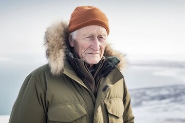 Fototapeta na wymiar Portrait of a senior man in winter clothes on a frozen lake