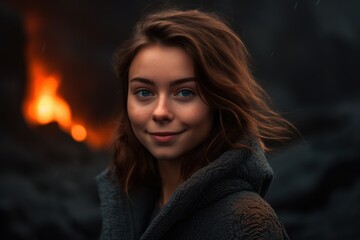 portrait of a beautiful girl on a background of a burning fireplace