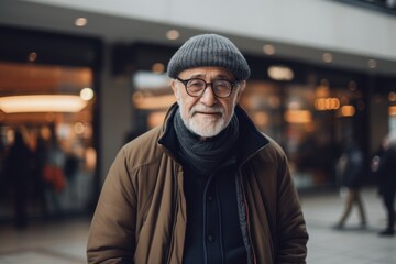 Fototapeta premium Portrait of a senior man wearing a hat and coat in the city