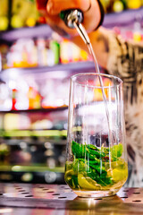 man hand bartender making cocktail in glass on the bar counter