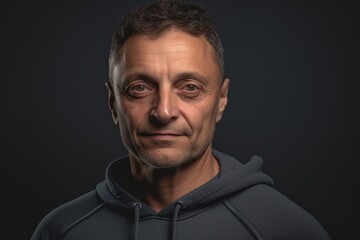 Obraz premium Portrait of a handsome middle-aged man on a dark background