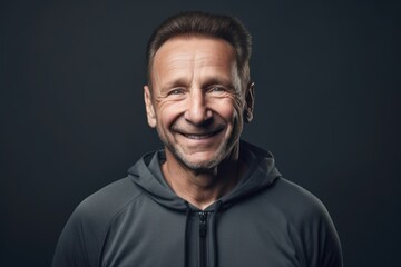 Portrait of smiling middle-aged man in black sweatshirt.