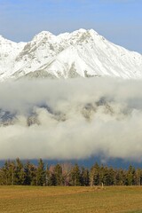 Fototapeta na wymiar Landscape with clouds overlooking snowy mountain.