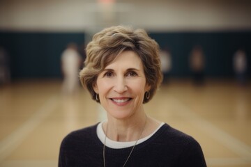 Portrait of a smiling senior woman looking at camera in a gym