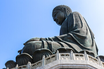 Looking up the side of the Tian Tan Big Bronze Buddha statue of Buddha Amoghasiddhi in Ngong Ping, Lantau Island, Hong Kong