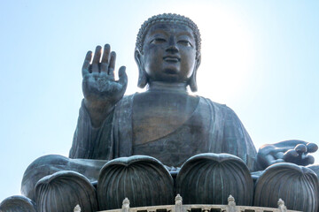 The Tian Tan Big Buddha Statue of Buddha Amoghasiddhi sitting and waving at Ngong Ping, Lantau Island, Hong Kong