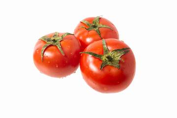 Three red ripe tomatoes on a white isolated background