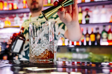 man hand bartender making cocktail in glass on the bar counter
