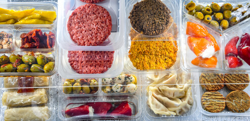 Variety of prepackaged food products in plastic boxes