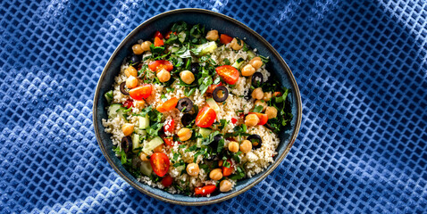 A plate of couscous served with vegetables and chickpeas