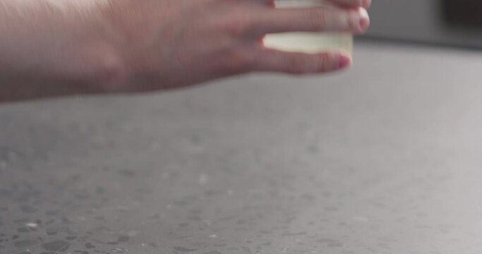 Slow motion man take glass with lemonade with orange lemon