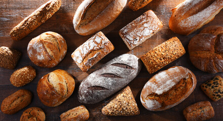 Assorted bakery products including loaves of bread and rolls