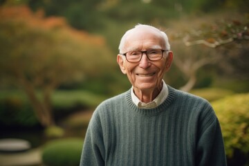 Portrait of a smiling senior man in the garden. Focus on his face.