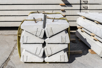 Reinforced concrete steps are tied with slings for loading into a truck.