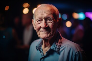 Portrait of an elderly man in a nightclub with lights on background