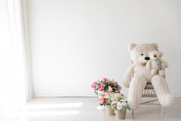 small toys on the chair and beautiful pink flowers in the room for the holiday interior