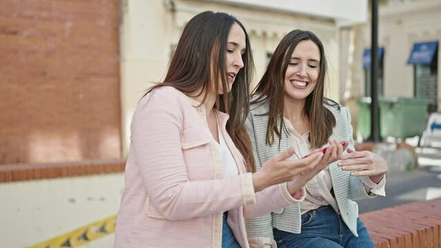 Two women smiling confident make selfie by smartphone at street