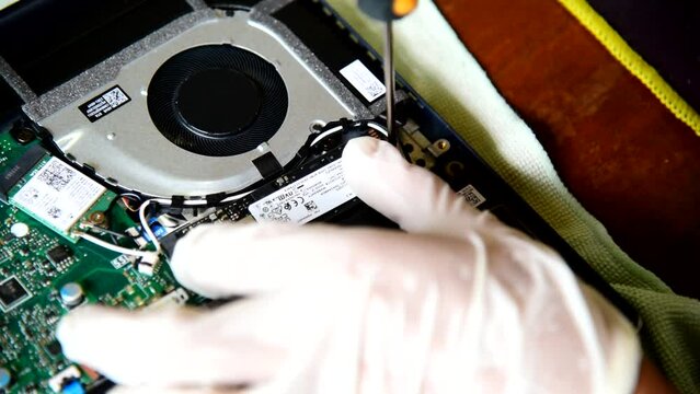 Bangkok,Thailand - May5 , 2023 : Use screwdriver turn the screw for remove  M.2 NVMe SSD storage in the Asus vivobook