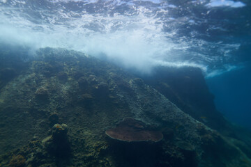 waves crash against rocks underwater