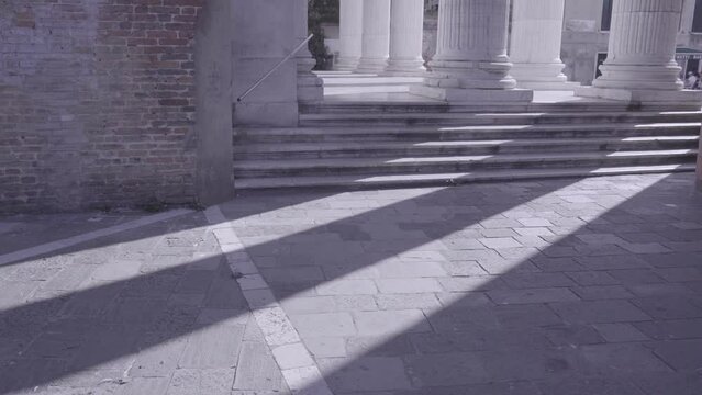 stone steps to antique columns on city square in Venice