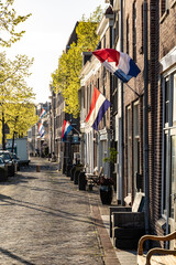 Quiet street at sunset with developing Dutch flags, Alkmaar