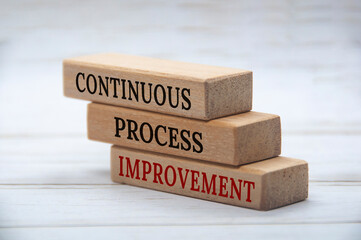 Continuous Process Improvement text on wooden blocks. Business culture and process improvement concept