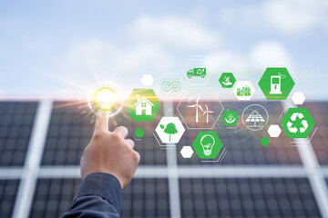 Hand with an icon of energy in front show symbols of various energies with a solar cell in the background, Concepts of clean energy source for renewable. power from the environment to save the world.