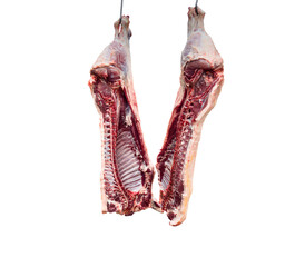Meat industry. Beef meat hanging. Cut and hanged on hook in a slaughterhouse isolated on a white background. Fresh lamb and raw meat. Сow carcass isolated..