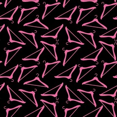 SEAMLESS PATTERN BLACK BACKGROUND WITH PINK CLOTHES HANGERS 