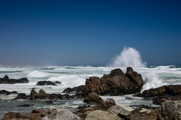 Rocky beach at Tsaarbank in West Coast national Park, Langebaan with waves crashing on the rocks.