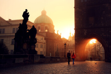 Mother and daughter at Charles Bridge during sunset 
