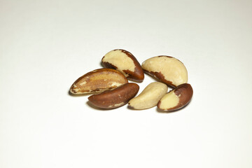 Several brazil nuts on a white background.