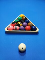 Pool billiard balls with triangle rack on bluetable sport game set