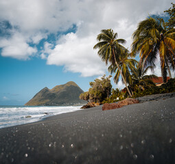 Dramatic seascape landscape of the beautiful wild tropical Diamant beach with its layered woman...
