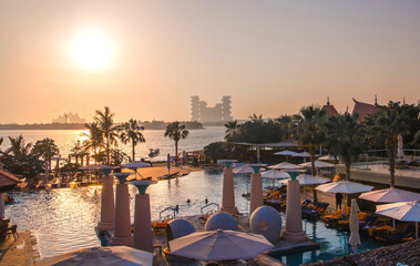 Dubai, UAE. Holidays villas at Palm Jumeirah and Atlantis hotel at distant at sunset