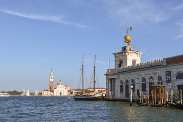 Fototapeta premium Punta della Dogana with the Dogana da Mar art museum and the San Giorgio Maggiore island in the background, Venice, Veneto, Italy