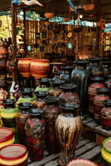 Fototapeta premium Beautiful colorfully painted terracotta pots, handicraft works, for sale during the Crafts Fair in Aregua.