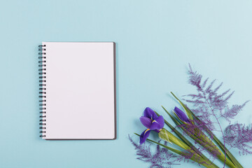 Mother's or Women's Day mock up card from spring irises flowers. Blank diary, notepad mockup with...
