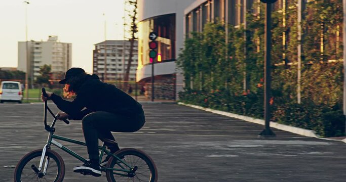 Sports, action and bmx with man and bike for energy, stunts and cycling tricks in city park. Fitness, health and jump with athlete riding on bicycle for extreme exercise, danger and speed in summer